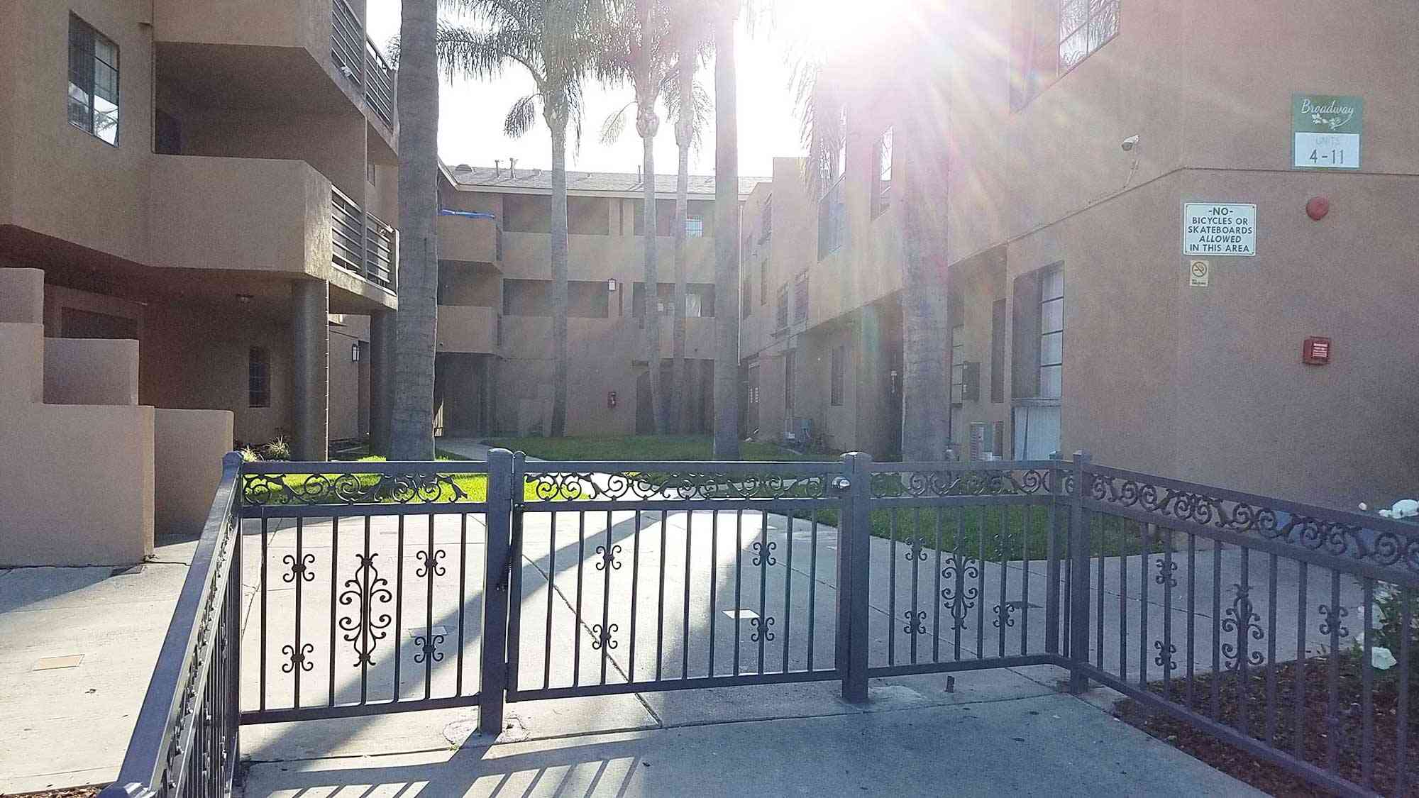 gated community entrance with wrought iron fence
