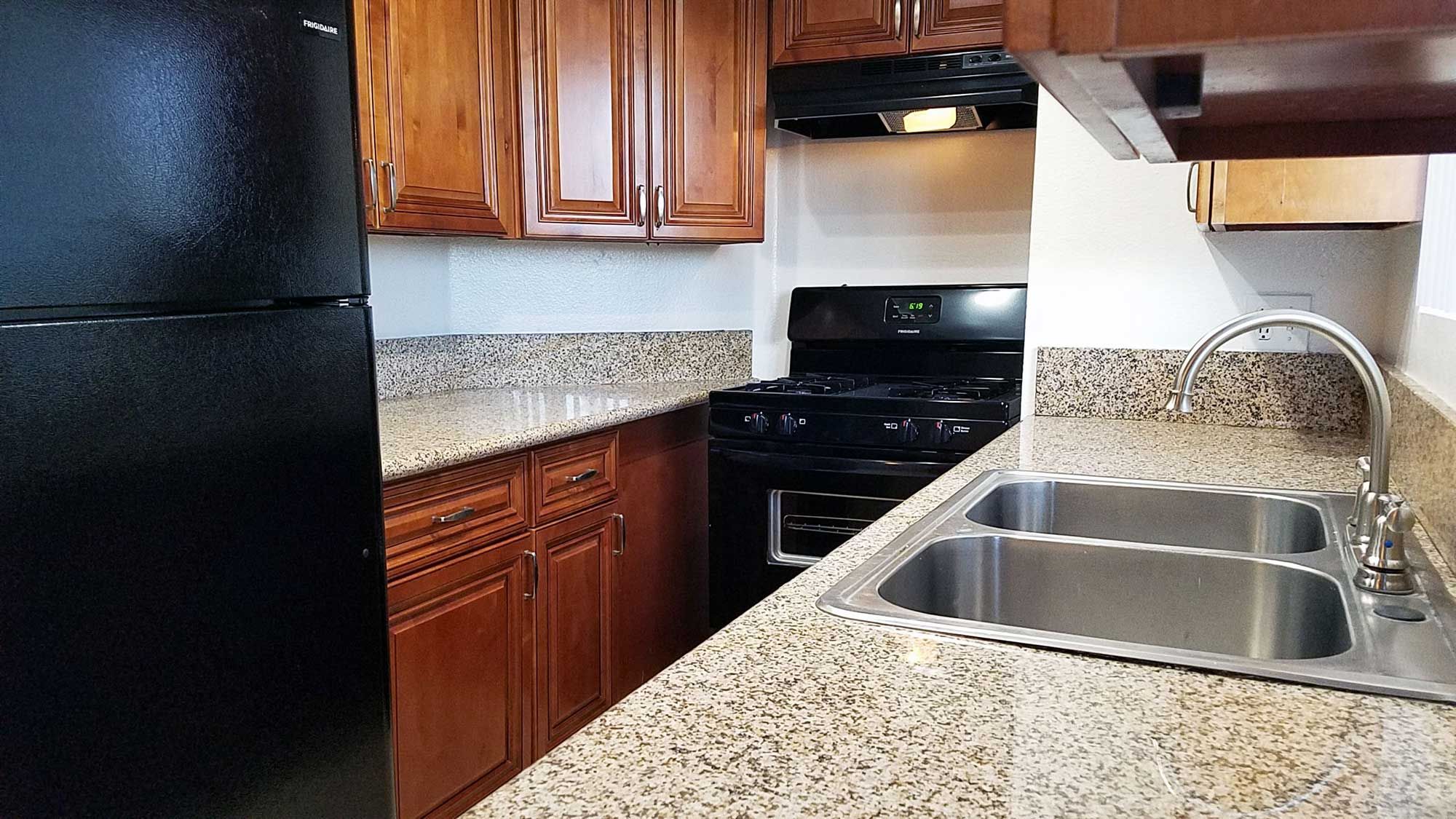 Broadway Apartments renovated kitchen with granite countertops