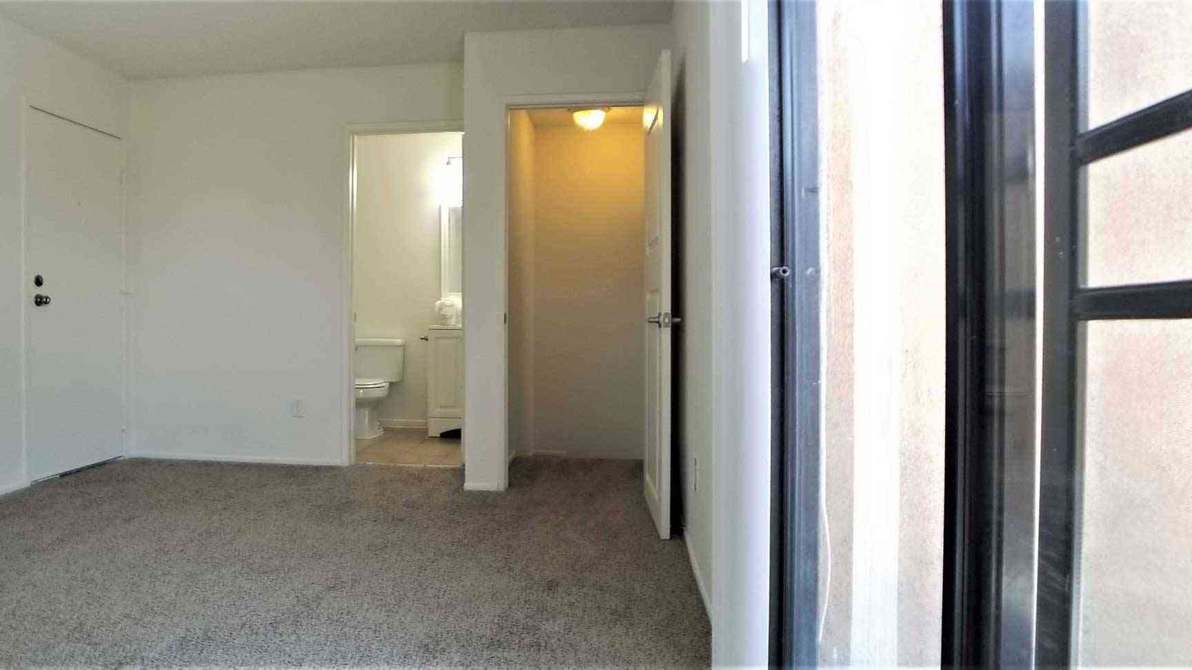 carpeted master bedroom with en suite bathroom